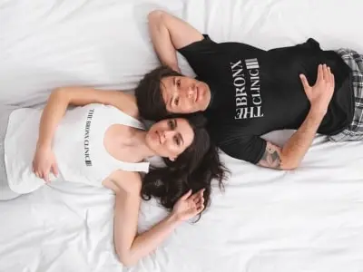 the bronx clinic couple laying on backs in the bronx clinic tshirt